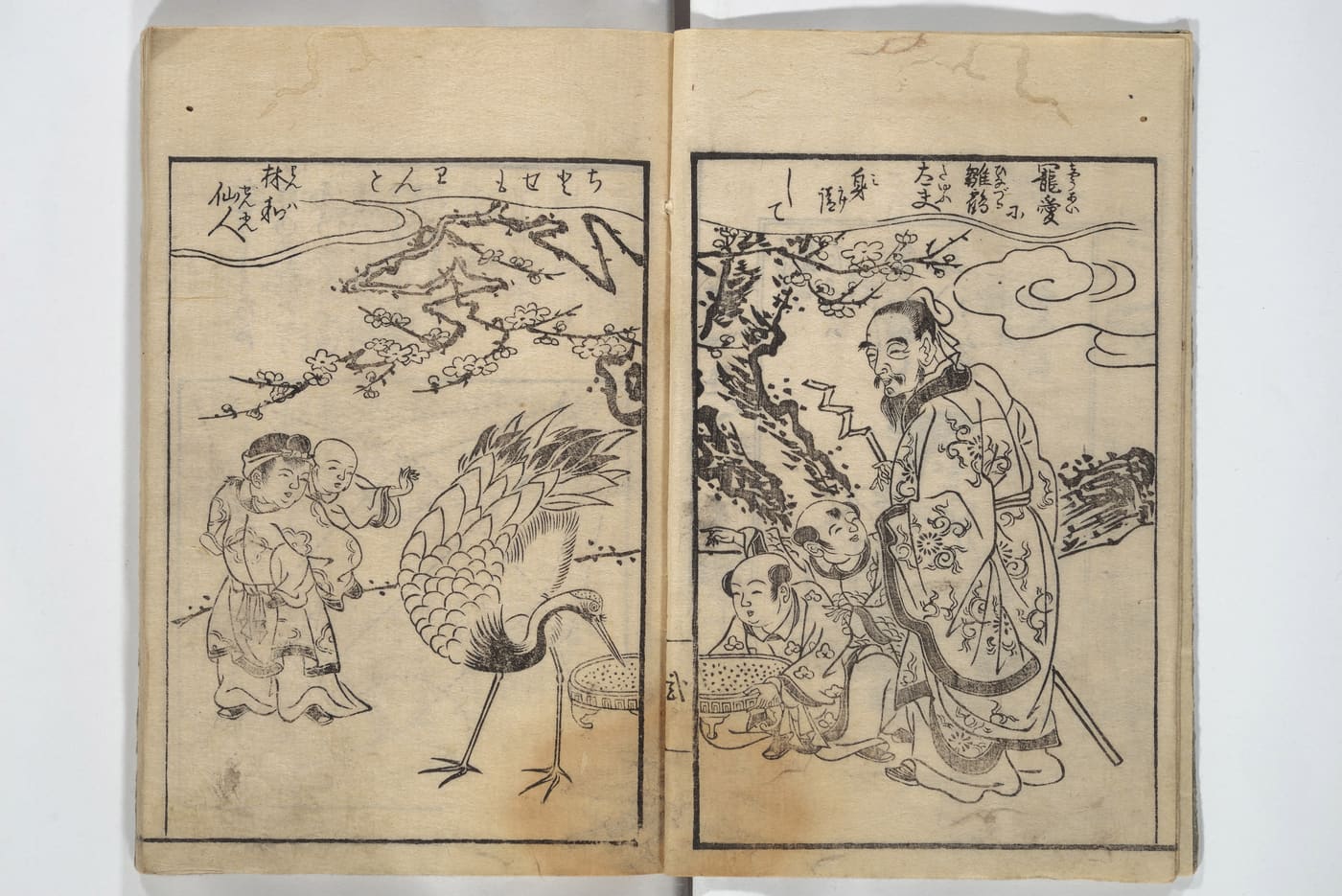 An open woodblock-printed book from 1797 showing a crane feeding beside children under a plum tree